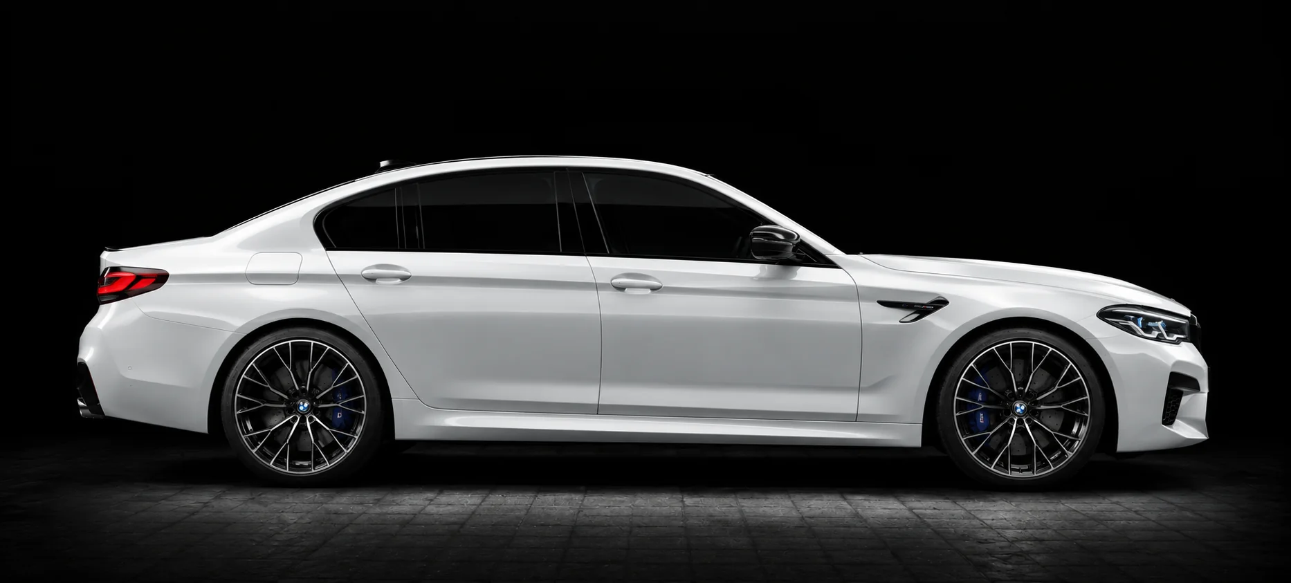 A white BMW saloon in side profile under studio lights, the kind of car available on a personal lease in Malta